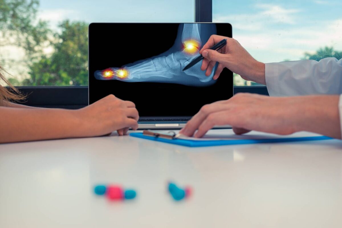 Physical therapist shows a patient a foot X-ray